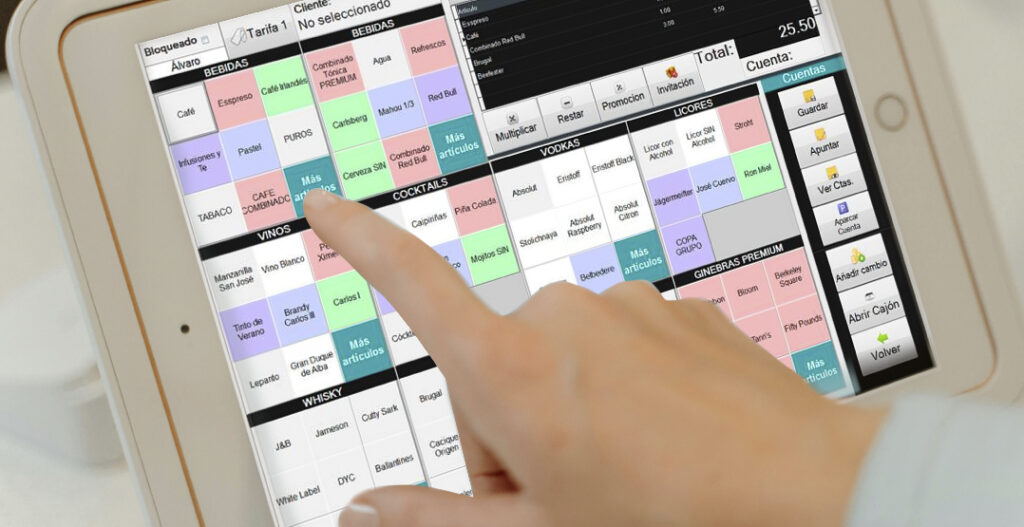 Una mano interactúa con la pantalla táctil de una tablet que muestra la interfaz del software TPV Numier, con categorías de bebidas, vinos y cócteles para hostelería.